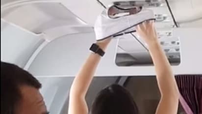 വിമാനത്തിലെ എസിയ്ക്ക് താഴെ അടിവസ്ത്രമുണക്കുന്ന യുവതി; വൈറലായി വീഡിയോ