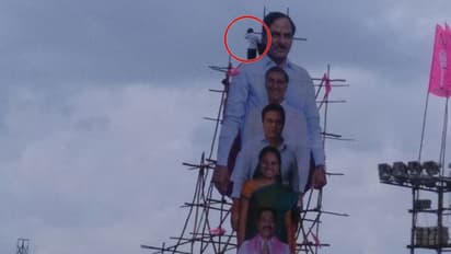 Telangana village head climbs on top of massive KCR cutout to protest