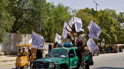 Members of the Taliban carrying flags participate in a rally to mark the third anniversary of the fall of Kabul, in Kabul, Afghanistan (File Image/Reuters)