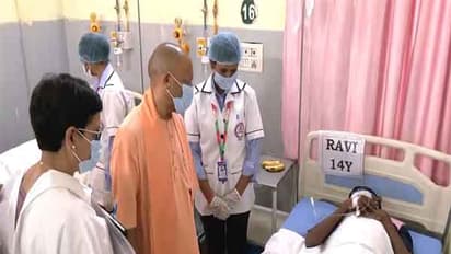 Chief Minister Yogi Adityanath meets children affected by food poisioning (Photo/ANI)