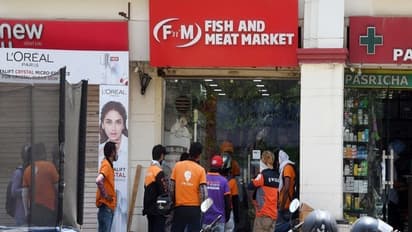 Delivery boys waiting outside store to pick their orders (Photo/ANI)  