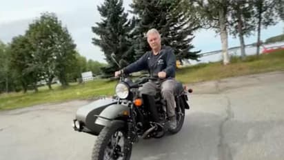 Alaska resident Mark Warren rides a Ural motorcycle gifted by Russian President Vladimir Putin, after receiving it from a Russian Embassy official in Anchorage, US (Photo/Reuters)