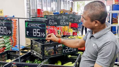 A salesman updates the price tag (File Photo/ANI)