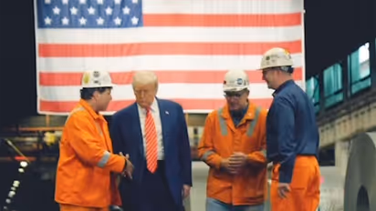 US President Donald Trump with factory workers (Image: X@USDOL)