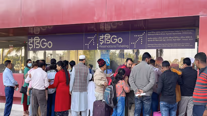 Passengers wait with their baggage as many IndiGo flight services stand cancelled (Photo/ANI)