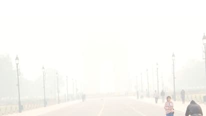 India Gate seems to disappear behind a layer of smog this morning. (Photo/ANI)