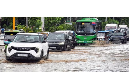 Vehicles wade through a waterlogged road after heavy rainfall in Guwahati (File Photo/ANI)