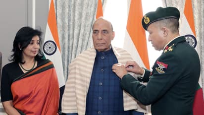 Defence Minister Rajnath Singh being pinned the Armed Forces Flag pin (Photo/X @rajnathsingh)