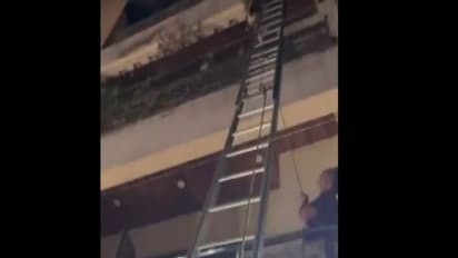 Firefighters deploy ladders to rescue trapped residents (Photo/ANI)