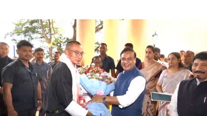 Assam Chief Minister Himanta Biswa Sarma welcomes Bhutan Prime Minister Tshering Tobgay with a floral bouquet upon his arrival in Guwahati. (Photo/ANI)