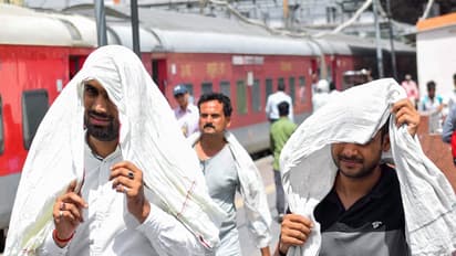 Commuters cover themselves with scarves to beat the scorching heat (Photo/ANI)