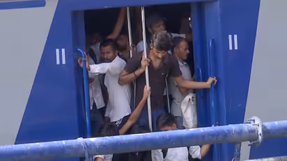 Students hang at train doors amid heavy rush (Photo/ANI)