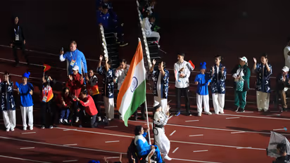 Mona Agarwal leading the Indian contingent with tricolour in hand. (Photo: PCI)