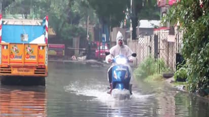 A commuter paves way through a waterlogged street due to heavy rainfall triggered by Cyclone Ditwah (Photo/ANI)