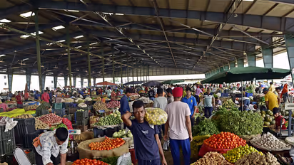 People buying vegetables at a wholesale market (File Photo/ANI)