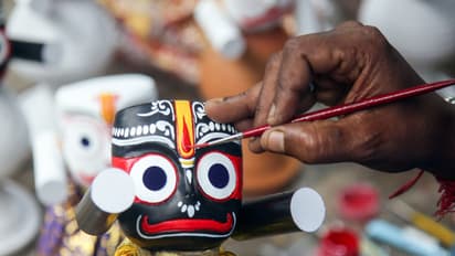 An artisan painting the facial features of a Lord Jagannath idol (Photo/ANI)