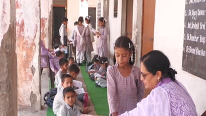 Students studying outside the government middle school due to cracked infrastructure in Udhampur (Photo/ANI)