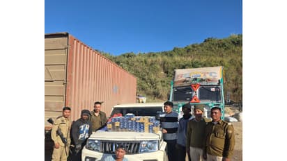 Police with seized cigarettes and heroin in Cachar district. (Photo/ANI)