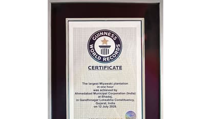 Officials of the Ahmedabad Municipal Corporation (AMC) receive the Guinness World Record certificate after successfully planting 3.61 lakh trees in one hour (Photo/@AmitShah)