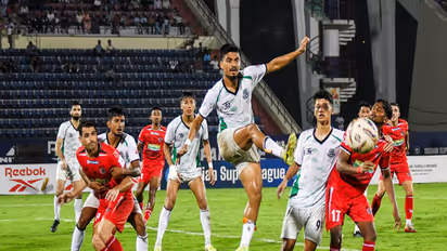 Players of North East United FC (in red) and Mohammedan SC (in white) during an ISL 2026 match (Photo: ANI)