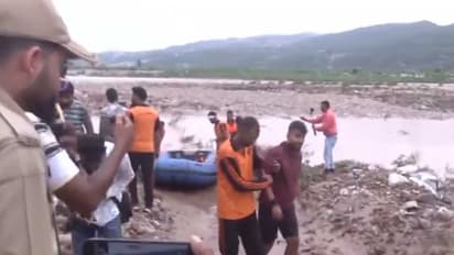 Jammu Police and NDRF personnel rescue one of the youths stranded in Tawi River (Photo/ANI)