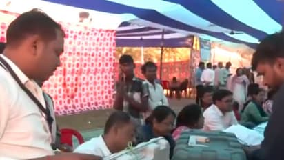 Presiding officers handing over EVMs to polling agents at a polling station in Patna (Photo/ANI)