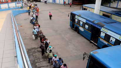 Commuters stand in a queue to board a bus as WBTC (Photo/ANI)