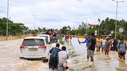 Floodwaters submerge Jorhat-Sivasagar highway in Assam, commuters struggle through waterlogged roads (Photo/ANI)