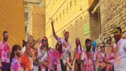 Foreign tourists playing Holi with locals in Jaisalmer (Photo/ANI)