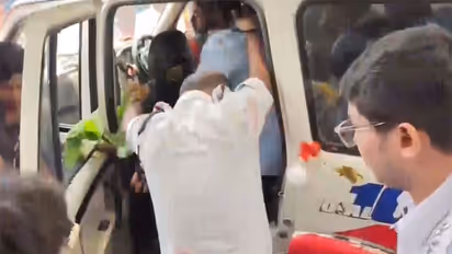 Police shield former Bidhannagar Mayor Sabyasachi Dutta as eggs and tomatoes are hurled at him while he is being taken away from police station (Photo/ANI)
