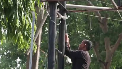 A person installing CCTV camera in an exam centre in New Delhi (Photo/ANI)