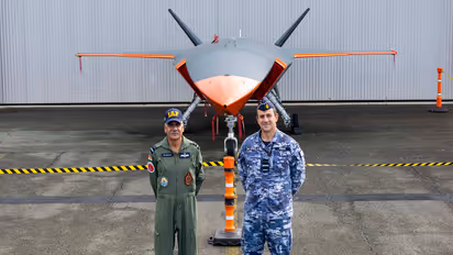 IAF Air Vice-Marshal Sanjeev Taliyan with Australian Deputy Chief of Air Force, Air Vice-Marshal Steven Pesce, with the MQ-28 Ghost Bat in the backdrop. (Photo/Australian Defence Ministry)