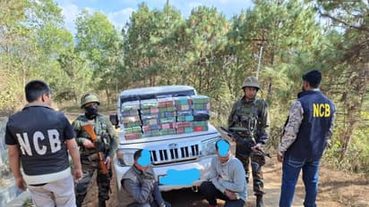 Narcotics Control Bureau (NCB) officials with arrested drug-traffickers in Imphal. (Photo/ANI)
