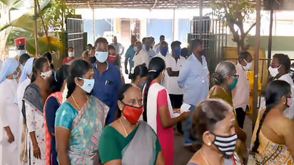 Voters standing in queue to cast their votes at a polling booth. (Photo/ANI)