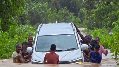 Locals wade through deep floodwaters to rescue stranded car in Odisha's Mayurbhanj (Photo/ANI)