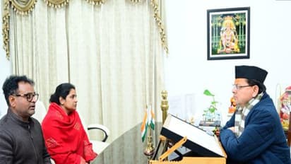 Chief Minister Pushkar Singh Dhami with wife and brother of late journalist Pankaj Mishra (Photo/ANI)