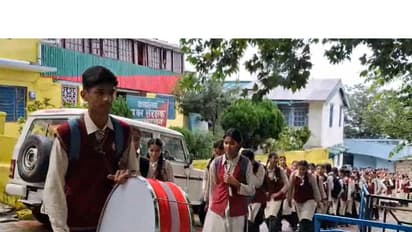 Student playing drums outside DFO office in Pauri Garhwal (Photo/ANI)