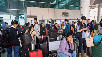 Flight passengers wait with their baggage as many IndiGo flight services stand cancelled in Delhi Airport (File Photo/ANI)