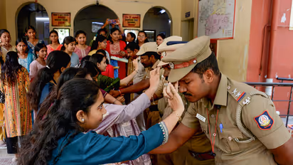 Students tie rakhis to police personnel on the eve of Raksha Bandhan festival (Photo: ANI)