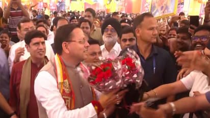 People greet Uttarakhand CM Pushkar Singh Dhami (Photo/ANI)
