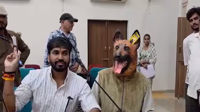 Khandwa Municipal Corporation Leader of Opposition Mullu Rathore with a person wearing a dog mask (Photo/ANI)