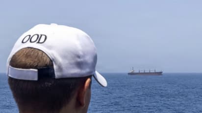 A US Navy Sailor monitors a merchant vessel in the Arabian Gulf (Photo/@CENTCOM)