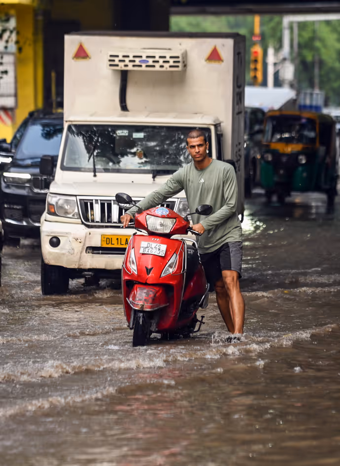 दिल्ली NCR-गाजियाबाद में बारिश की 10 तस्वीरें: बच्ची को पानी से बचाती दिखी मां तो कहीं जान जोखिम में डाल निकले लोग