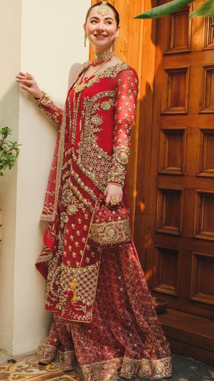 red hania amir bridal dress @haniaheheofficial is the epitome of grace and finesse in  @hussainrehar.official stunning berry-red Sarang ensemble. This ravishing  bridal outfit, rendered in a beautiful shade of berry red composed